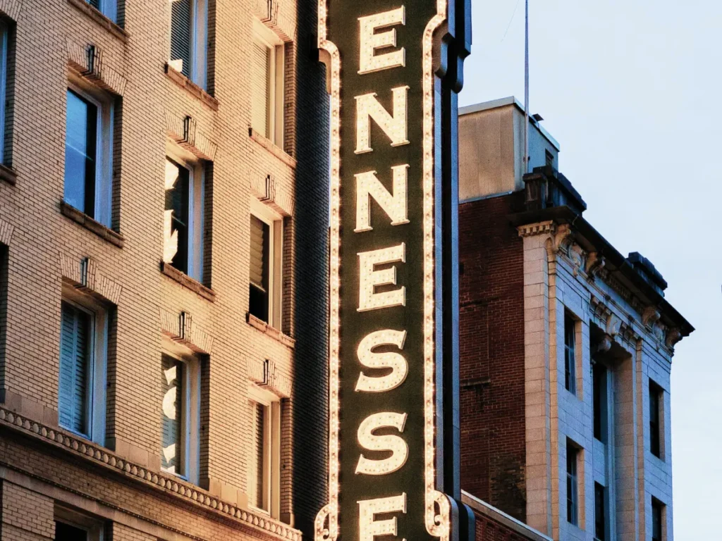 Tennessee sign illuminated on historic building in Belle Meade, showcasing the area's charm and connection to water damage restoration services.